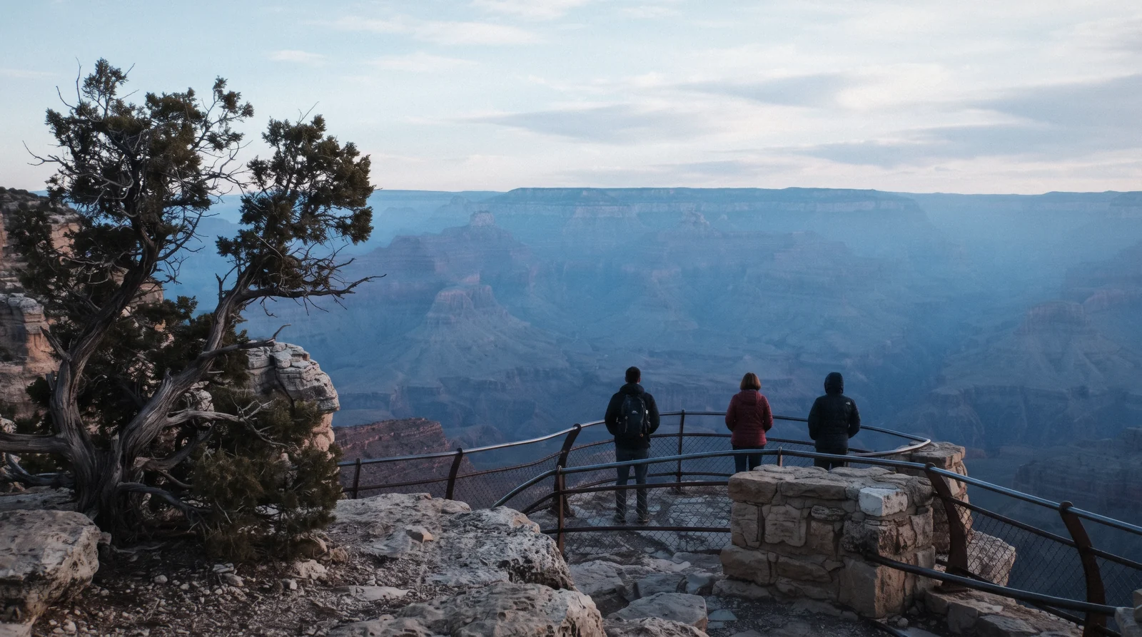 Grand Canyon South Rim at sunrise from a viewpoint near Mather Point, layered red and orange rock walls stretching toward the horizon, grand canyon from sedona