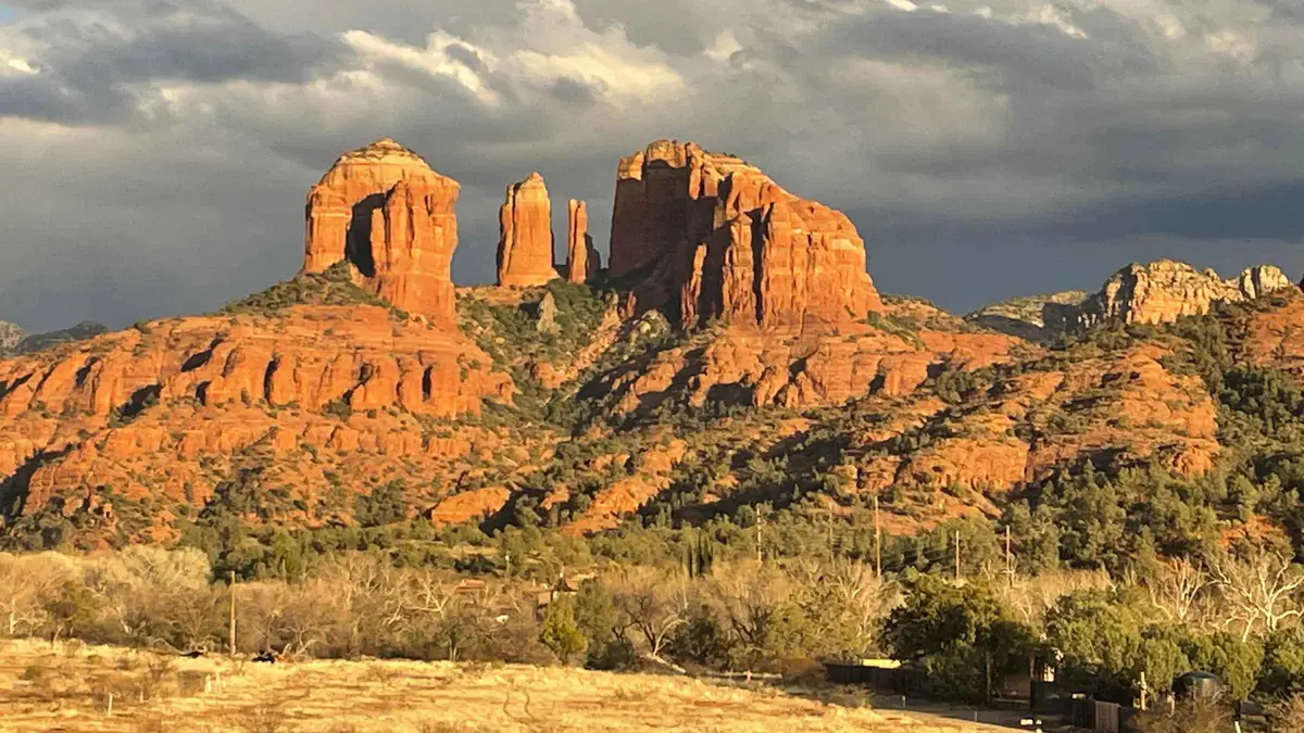 Riders on e-bikes approaching Cathedral Rock on a Sedona e-bike tour